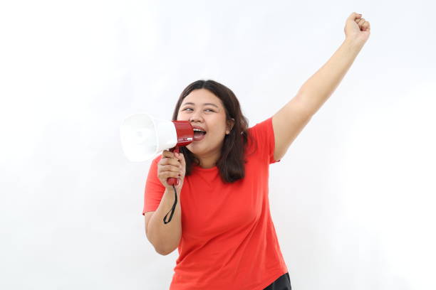 istock Happy asian woman shouting at megaphone, making announcement, advertising something, supporting standing over white background 2201614693