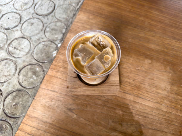 istock Morning cafe scene with a coffee cup on a wooden table near a window 2201615480