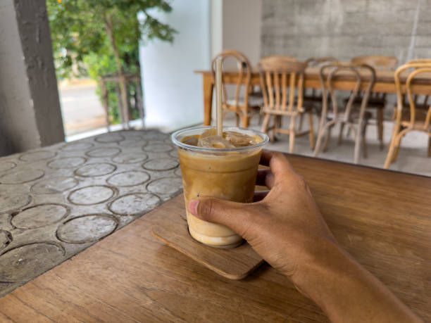 istock Morning cafe scene with a coffee cup on a wooden table near a window 2201615492