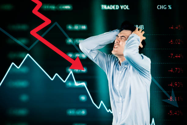 istock Stressed Investor Reacting to Stock Market Crash with Falling Graph 2201615651
