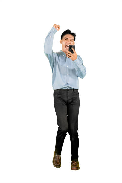 istock Excited Young Man Celebrating Success with Smartphone on White Background 2201615680