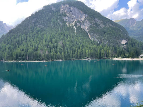 istock High mountain lake in Italy with clouds and turquoise blue water mountains. 2201618152