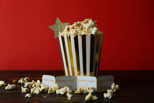 istock Paper box with popcorn, and tickets against red background 2201619402