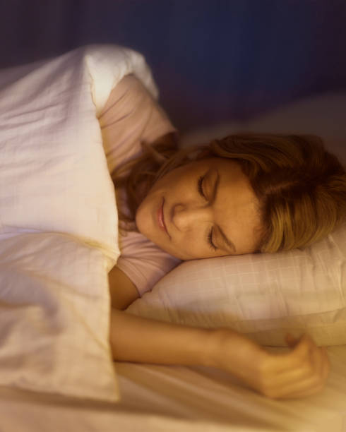 istock Relaxed woman sleeping in a bed at night. 2201623893