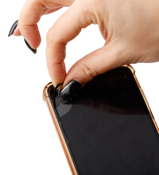 istock A hand is holding a cell phone with a cracked screen 2201627625