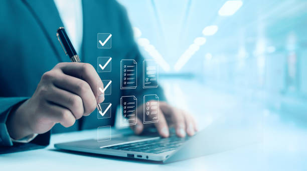 istock Business Performance Checklist Businessman Using Laptop Doing Online Checklist Survey On Computer Filling Out Digital Form Checklist Survey Doing Assessment Questionnaire Evaluation 2201629659