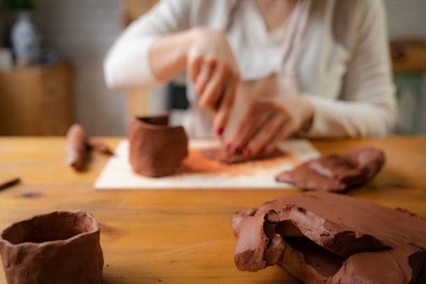 istock Woman potter shape wet clay 2201629986