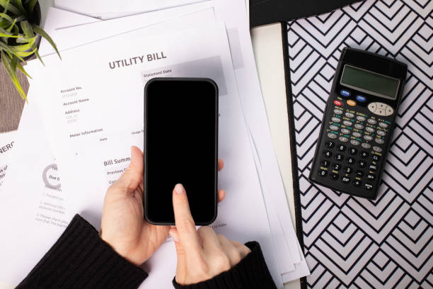 istock Online utility payments by bills, smartphone app for electricity transaction, customer managing home expenses 2201631746