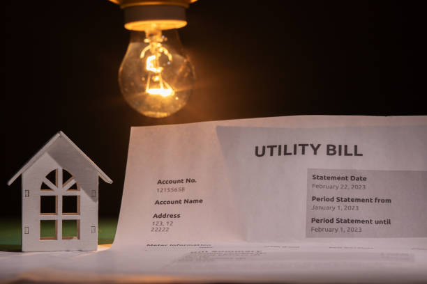 Utility bill and a house with a burning lightbulb, invoice for energy consumption and charges, cost calculation for home electricity, managing household expenses