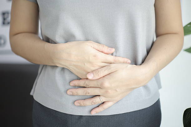 istock Stomach ache, Abdominal massage relieves stomach pain and constipation. 2201632256