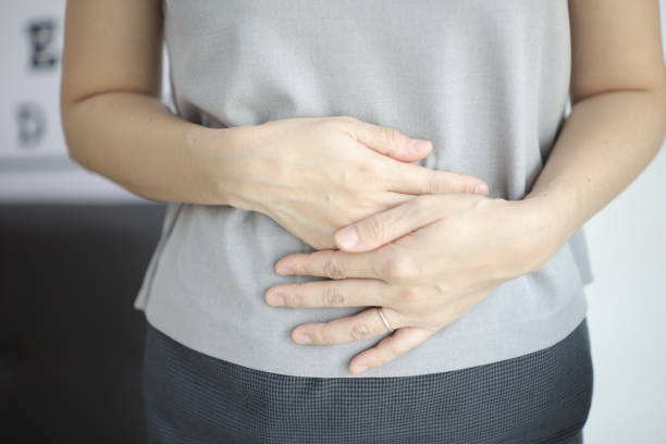istock Stomach ache, Abdominal massage relieves stomach pain and constipation. 2201632259