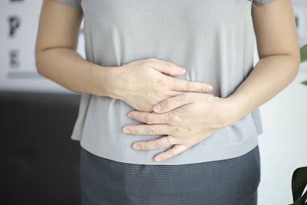 istock Stomach ache, Abdominal massage relieves stomach pain and constipation. 2201632266