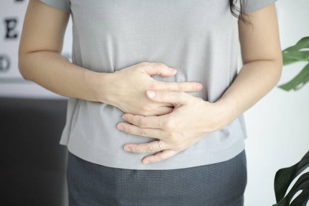 istock Stomach ache, Abdominal massage relieves stomach pain and constipation. 2201632271