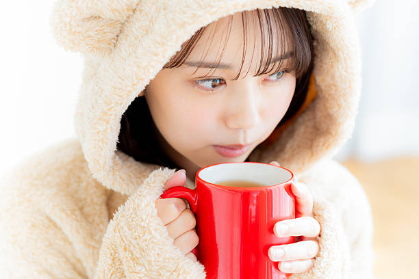young woman drinking hot drink