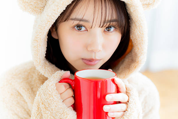 young woman drinking hot drink