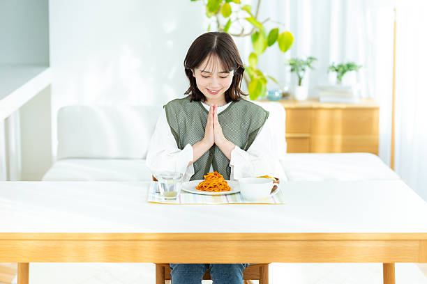 istock young woman eating pasta 2201632553