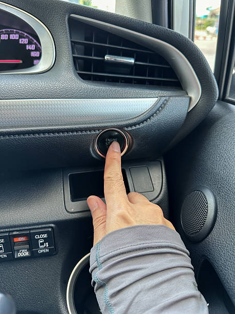istock finger pressing button the start button, stop the engine in the luxury car.Owner and dealership concept. 2201635551