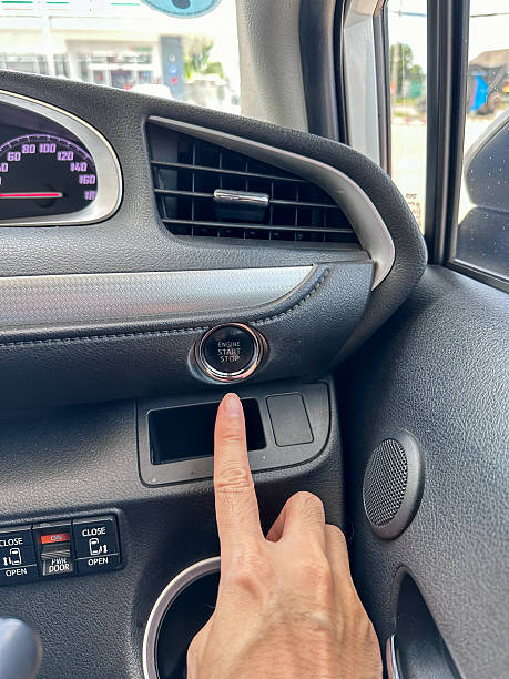 istock finger pressing button the start button, stop the engine in the luxury car.Owner and dealership concept. 2201635565