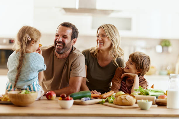 Cheerful family preparing healthy meal in the kitchen.