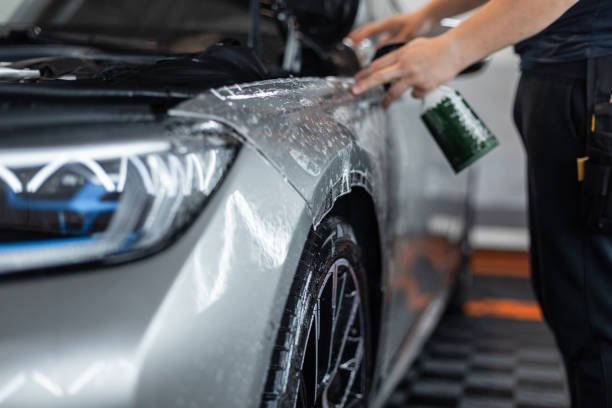istock professional man does car detailing and covers it with protective film at a detailing service 2201637208