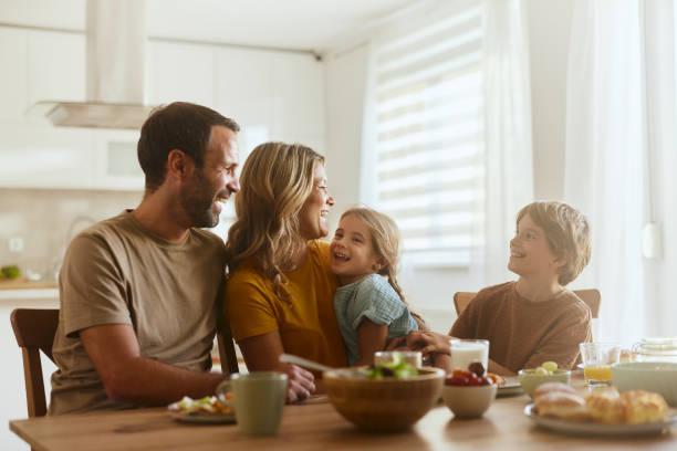 istock Happy family talking while enjoying in meal at dining table. 2201638670