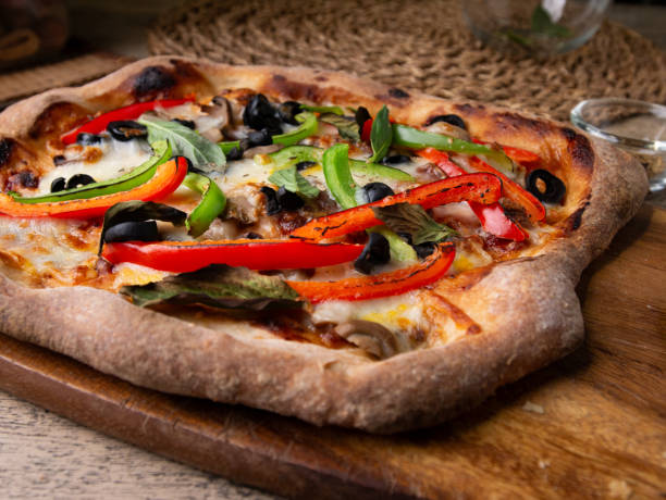 Homemade Sourdough pizza on Wooden Table.