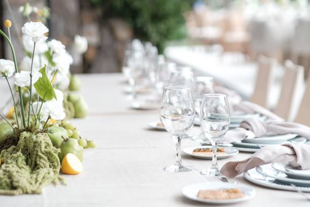 istock Elegant table setting with flowers and fruits. 2201645693