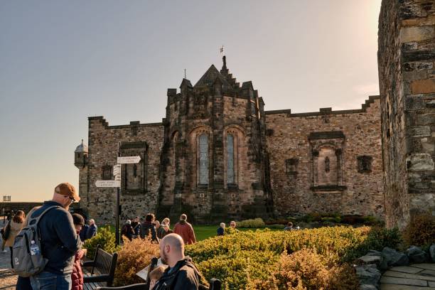 Edinburgh, United Kingdom – January 07, 2025: Visitors photograph St Margaret's Chapel at Edinburgh Castle on a sunny day