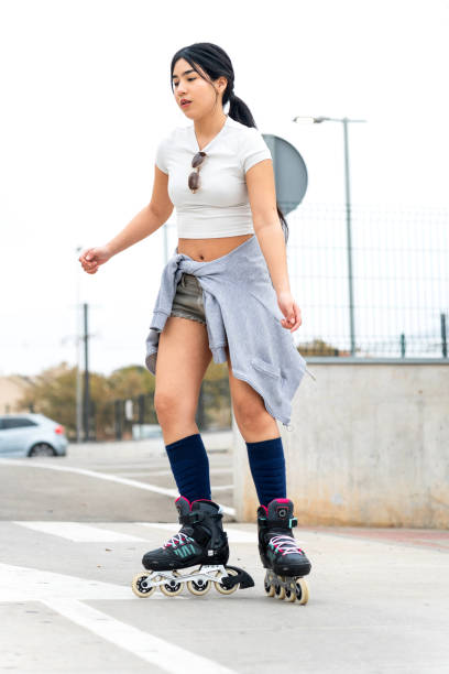 istock Young woman using inline skates as urban transportation 2201650277