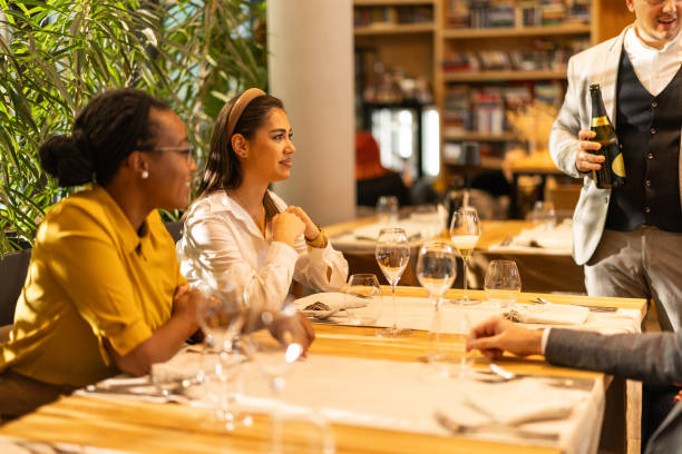 istock Multiracial group of people sitting in luxury restaurant 2201652695