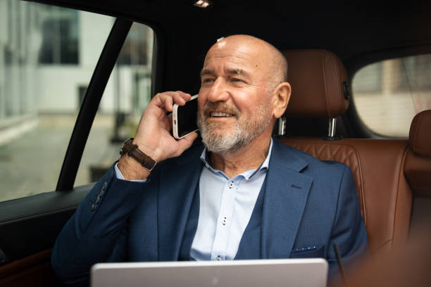 istock Senior businessman working from car 2201653455