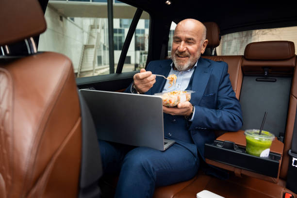 istock Senior businessman having a conference call from car 2201653566