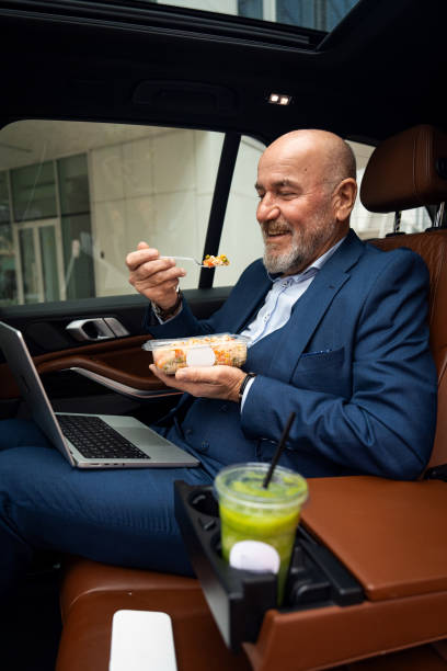 istock Senior businessman having a conference call from car 2201653589