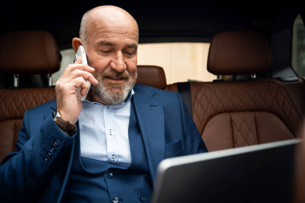 istock Senior businessman working from car 2201653688
