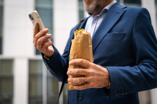 istock Business man using smart phone outside of commercial building 2201654014