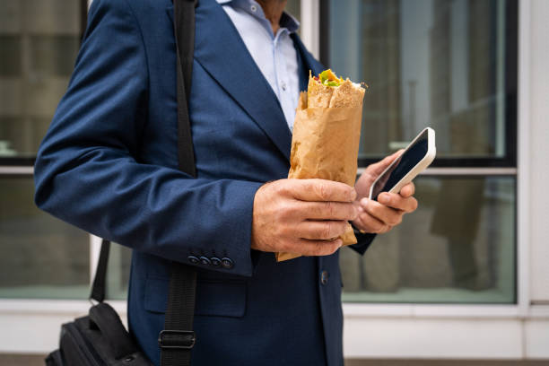 istock Businessman having a quick snack on his way to work 2201654022