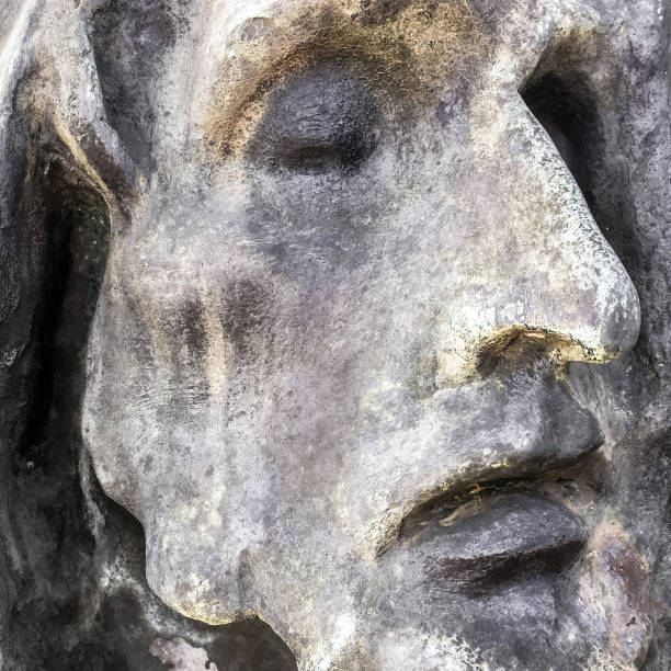 Stone statue of Jesus. Closeup of the face of Jesus Christ carved in stone