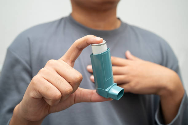 istock Asthma and chronic obstructive pulmonary disease COPD, Asian young man using metered dose inhaler MDI. 2201655932