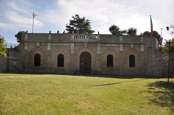 istock Historic brick building with arched windows in a park. 2201656782
