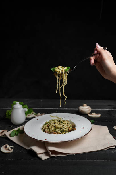 istock menu for a restaurant pasta with cheese on a fork noodles with vegetables on a black background 2201660097