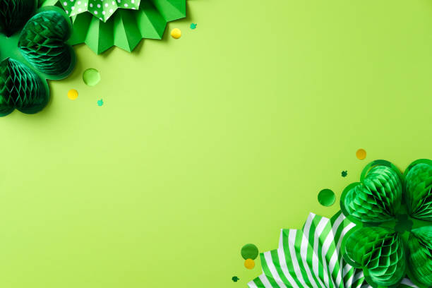 istock Happy St. Patrick's Day concept. Flat lay composition with honeycomb paper four leaf clover and decorative paper fans on green background 2201661539