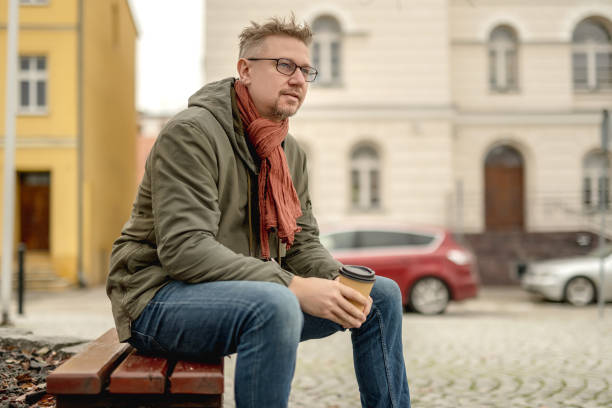 istock Young Attractive Man Sitting On Bench In Park 2201665123