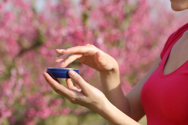 istock Woman hands holding moisturizer cream ready to apply in a field 2201667807
