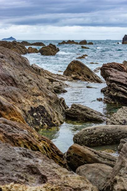 istock Rocky coastal landscape with waves and cloudy sky. 2201672535