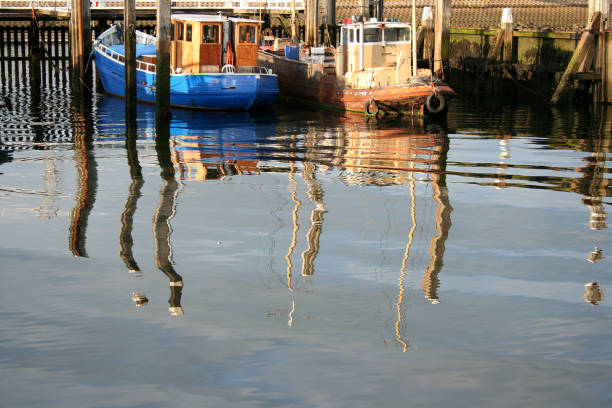 Netherlands, Bruinisse, july 2016: reflections of fishingboats in the harbour