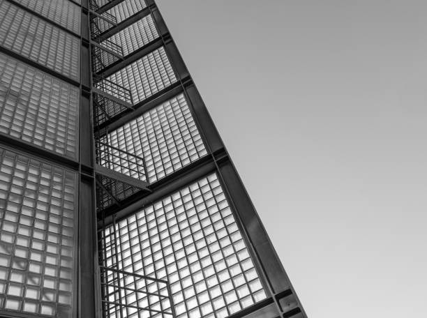 Germany, Berlin, Moabit, February 20, 2025 -Low angle view of modern glass facade of a tower