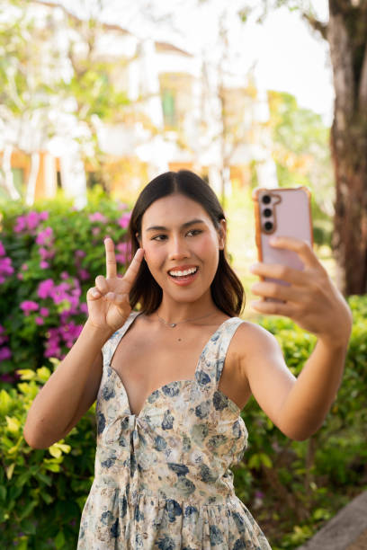istock Young Asian woman smiling in garden 2201676889
