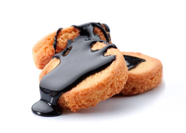 istock Delicious cookies drizzled with rich chocolate sauce on a white background 2201676991