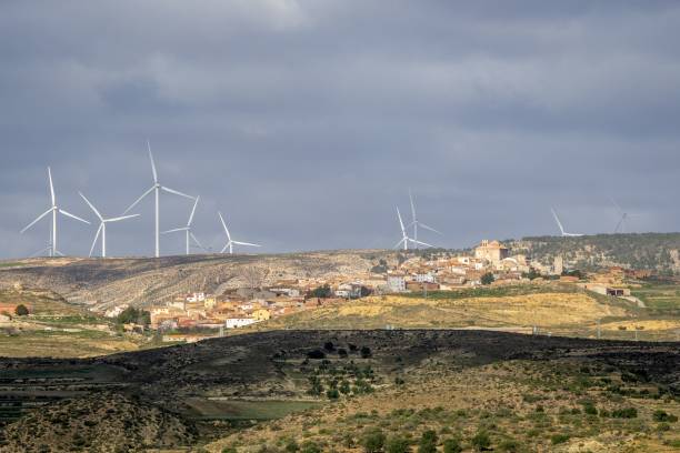 istock Rural village with wind turbines on a cloudy day 2201680009
