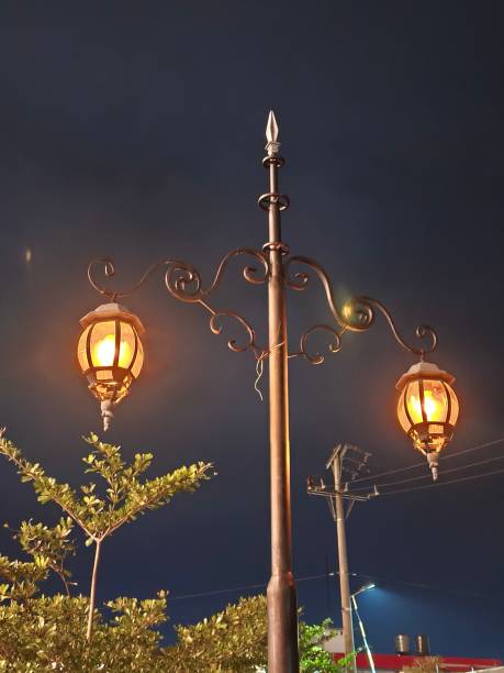 istock poles and lights in the city park at night 2201681618